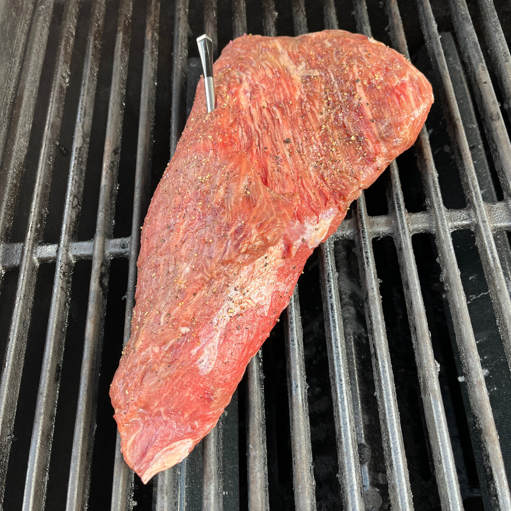 Raw piece of meat on a grill